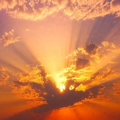 Sun rays bursting through orange clouds