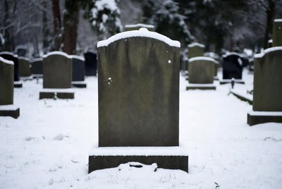 Blank gravestone in snowy cemetery