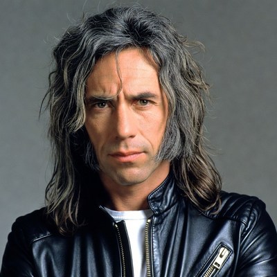 Man with long gray hair in leather jacket
