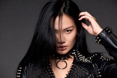 Asian woman in spiked leather jacket
