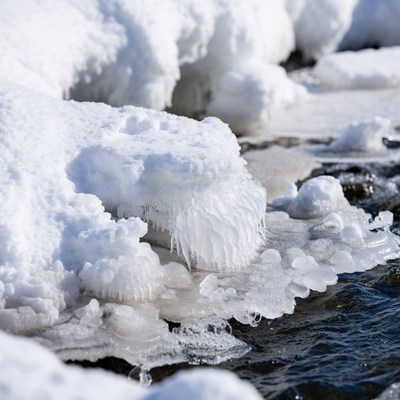 Icicles on snowy river edge