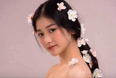 Asian woman with flowers in black hair