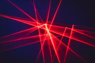 Red laser beams on dark background