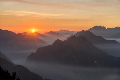 Sunrise over misty mountains