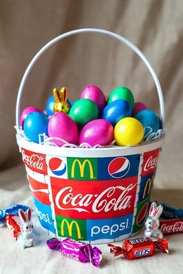Easter Basket with Colored Eggs and Candy