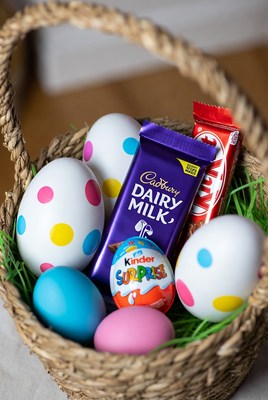 Easter Basket with Colored Eggs and Chocolates
