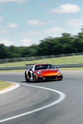 Orange Porsche racing on track