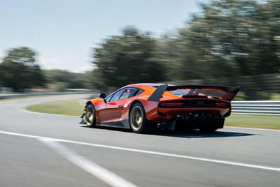 Orange Supercar Speeding on Racetrack
