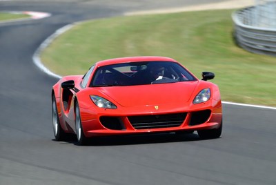 Red Ferrari racing on track