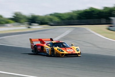 Red Orange Race Car Speeding on Track