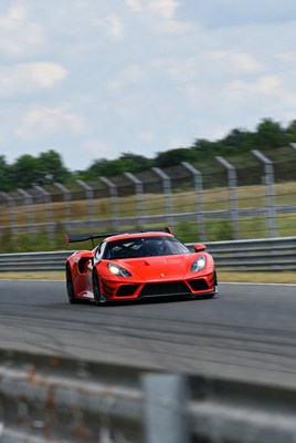 Red Ferrari racing on track