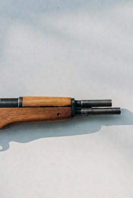 Double Barrel Shotgun on Blue Background