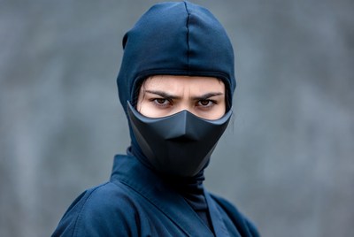 Woman in black ninja mask