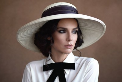 Woman in wide-brim hat and bow tie