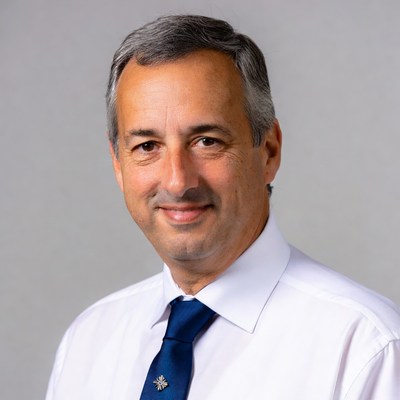 Smiling man in white shirt and blue tie
