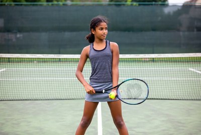 Young Black girl holding tennis racket