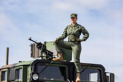 Female soldier posing on Humvee machine gun