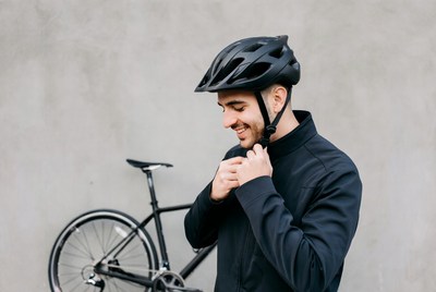Man adjusting bike helmet