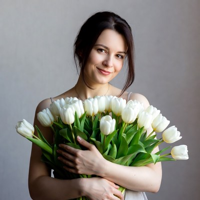 Woman holding white tulips