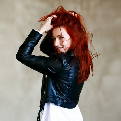 Woman with red hair in leather jacket