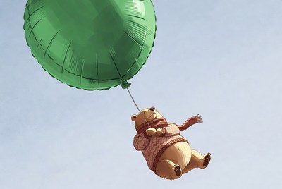 Bear flying with green balloon