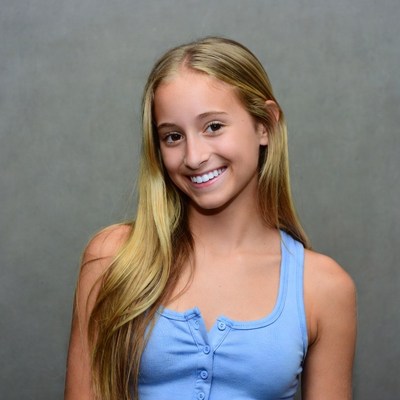 Smiling blonde girl in blue tank top
