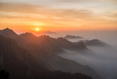 Sunrise over misty mountains
