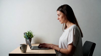 Woman working on laptop at desk