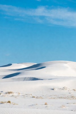 White sand dunes under blue sky