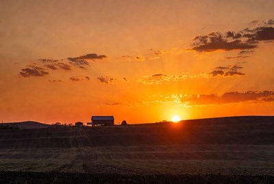 Barn silhouetted against sunset