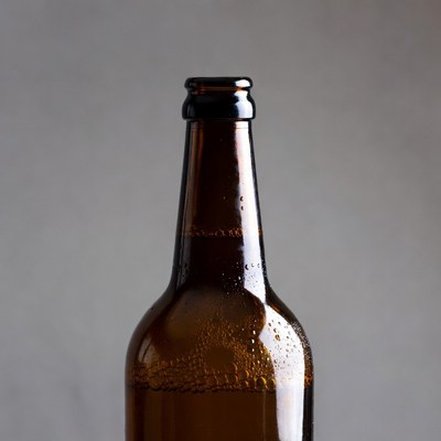 Condensation-covered brown beer bottle