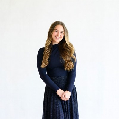 Smiling young woman in navy dress