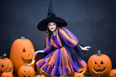 Woman in Witch Costume with Pumpkins
