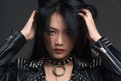 Asian woman in studded leather jacket