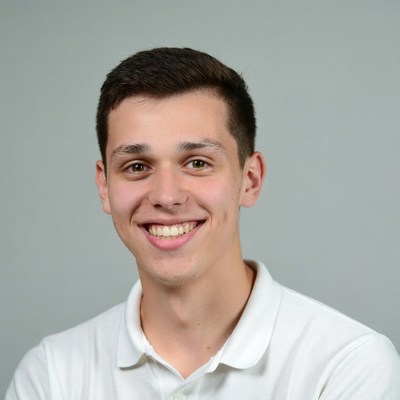 Smiling young man in white polo shirt