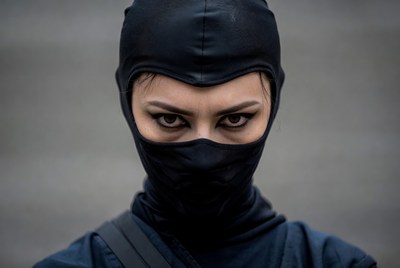 Asian woman in black ninja mask