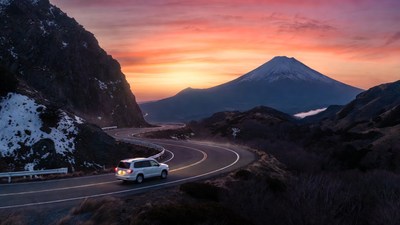 White SUV Driving Mount Fuji Sunset