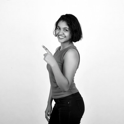 Smiling Indian woman pointing finger