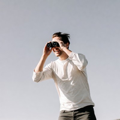 Man using binoculars outdoors