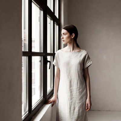 Woman gazing out large window