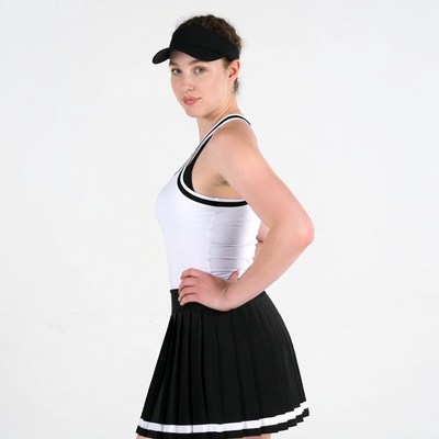 Woman in tennis outfit posing sideways