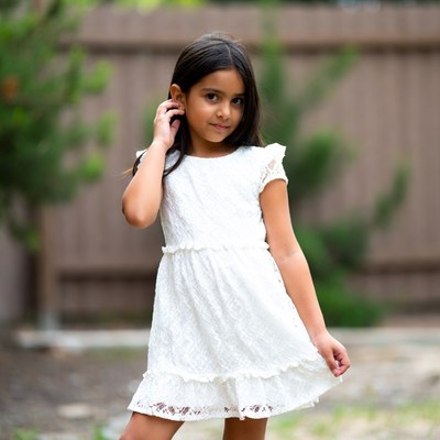 Young girl in white lace dress outdoors
