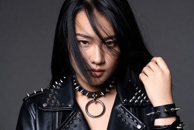 Asian woman in spiked leather jacket