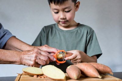 Boy and Grandma Peeling Sweet Potatoes