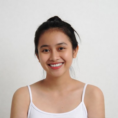 Smiling Asian woman in white camisole