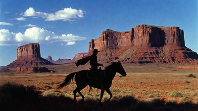 Cowboy riding horse in Monument Valley