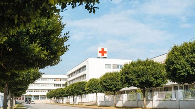 Hospital Building with Red Cross Sign