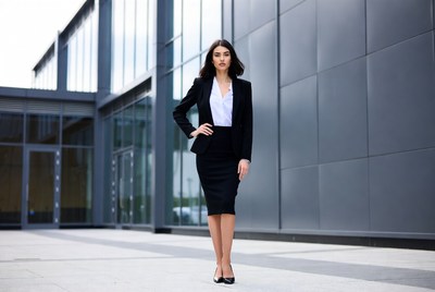 Business woman in black suit outside