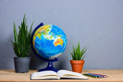 Globe with open book and colored pencils