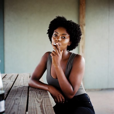 African-American woman smoking cigarette